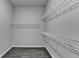 Walk-in closet featuring wire shelving and gray flooring at 1043 Harvest Park Ln, Suwanee, GA 30024