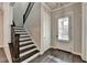 Open entryway featuring dark wood flooring and a staircase with dark wood and white risers at 1043 Harvest Park Ln, Suwanee, GA 30024