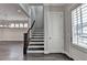 Entryway features staircase, door, and window with views of a dining room and living room at 1043 Harvest Park Ln, Suwanee, GA 30024