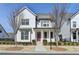 Charming two-story home with a white board and batten exterior and a welcoming front porch at 1043 Harvest Park Ln, Suwanee, GA 30024