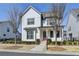 Beautiful two-story house featuring white siding, black shutters, and a well-manicured front yard at 1043 Harvest Park Ln, Suwanee, GA 30024