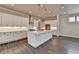 Bright kitchen featuring white cabinets, a large island with seating, and stainless steel appliances at 1043 Harvest Park Ln, Suwanee, GA 30024