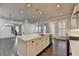 Open-concept kitchen with a central island, pendant lights, and ample counter space at 1043 Harvest Park Ln, Suwanee, GA 30024