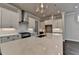 Bright kitchen featuring quartz countertops, white cabinetry, stainless appliances, and modern pendant lighting at 1043 Harvest Park Ln, Suwanee, GA 30024