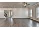 Open concept living room with hardwood floors, shiplap wall, and view to the staircase at 1043 Harvest Park Ln, Suwanee, GA 30024