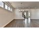Open-concept living room with hardwood floors, ample natural light, and view into a modern kitchen at 1043 Harvest Park Ln, Suwanee, GA 30024