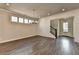 Bright, open-concept living room showcasing hardwood floors, natural light, and modern chandelier at 1043 Harvest Park Ln, Suwanee, GA 30024