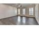 Living room with hardwood flooring, plenty of natural light, and shiplap accent wall at 1043 Harvest Park Ln, Suwanee, GA 30024