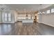 Spacious open-concept living area featuring hardwood floors, white walls and natural light at 1043 Harvest Park Ln, Suwanee, GA 30024