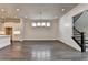 Spacious living room showcasing hardwood floors, modern lighting, and an open floor plan at 1043 Harvest Park Ln, Suwanee, GA 30024