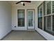Covered patio featuring a ceiling fan, door, and windows with bright white trim at 1043 Harvest Park Ln, Suwanee, GA 30024