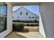 View from the patio to the yard and a white house with black trim at 1043 Harvest Park Ln, Suwanee, GA 30024