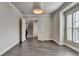 Modern room features hardwood floors, crown molding and a glimpse of the stairs at 1043 Harvest Park Ln, Suwanee, GA 30024