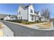 Charming street view of new construction homes featuring black fence and landscaping at 1043 Harvest Park Ln, Suwanee, GA 30024