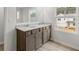 Bathroom features double sinks, granite counters, wood cabinets and hardwood floors at 113 Hampton Ter, Dallas, GA 30157