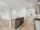 Open-concept kitchen with a central island, stainless steel appliances, and luxury vinyl plank flooring at 113 Hampton Ter, Dallas, GA 30157