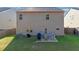 A fenced backyard with a small patio set and some outdoor furniture at 1152 Werre Way, Locust Grove, GA 30248