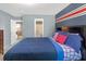 Bright bedroom with an en suite bath features blue walls, red and white accents, and carpeted floors at 1152 Werre Way, Locust Grove, GA 30248