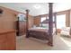 Elegantly furnished bedroom with a four-poster bed, dresser, and soft color palette at 1152 Werre Way, Locust Grove, GA 30248