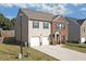 Side view of a two-story home showing the driveway and a partial view of the backyard at 1152 Werre Way, Locust Grove, GA 30248
