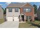 Charming two-story home with a brick and siding exterior and a two-car garage at 1152 Werre Way, Locust Grove, GA 30248