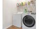 Functional laundry room with a front-load washer and dryer set, complete with storage shelves at 1152 Werre Way, Locust Grove, GA 30248