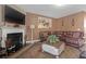 Warm living room with a fireplace, mounted TV, and comfortable leather seating at 1152 Werre Way, Locust Grove, GA 30248