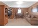 Comfortable living room with a built-in entertainment center, bar area, and plush sofa at 1152 Werre Way, Locust Grove, GA 30248