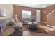 Inviting living room with neutral decor and plush seating and hardwood floors at 1152 Werre Way, Locust Grove, GA 30248