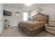 Bright main bedroom featuring a king-sized bed, neutral decor, and a cozy armchair at 1152 Werre Way, Locust Grove, GA 30248