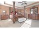 An impressive main bedroom with carpet floors, a four-poster bed, and matching dressers and nightstands at 1152 Werre Way, Locust Grove, GA 30248