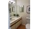 Bathroom featuring a single sink vanity, framed mirror, and wood look flooring at 118 Hawkstone Way, Alpharetta, GA 30022