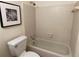 Bathroom showcasing a shower-tub combo and a toilet in a cozy interior at 118 Hawkstone Way, Alpharetta, GA 30022