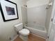 Bathroom featuring a shower-tub combo and a toilet in a cozy interior at 118 Hawkstone Way, Alpharetta, GA 30022