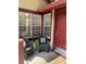 Cozy front porch featuring a seating area and a bright red front door at 118 Hawkstone Way, Alpharetta, GA 30022