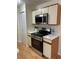 Bright kitchen featuring updated stainless steel appliances and white countertops at 118 Hawkstone Way, Alpharetta, GA 30022