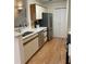 Kitchen featuring stainless steel appliances, light countertops, and white cabinets at 118 Hawkstone Way, Alpharetta, GA 30022