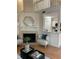Cozy living room with a fireplace, plush seating, and an open view to the kitchen at 118 Hawkstone Way, Alpharetta, GA 30022