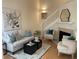 Cozy living room with comfortable seating, a fireplace, and stairs to the upper level at 118 Hawkstone Way, Alpharetta, GA 30022
