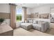 Cozy bedroom featuring a comfortable sectional sofa, neutral decor, and natural light at 1654 Tide Mill Rd, Cumming, GA 30040