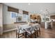 Open-concept dining area with modern furniture and a view of the kitchen at 1654 Tide Mill Rd, Cumming, GA 30040
