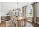 Elegant dining room with wood floors, stylish lighting, and a large window at 1654 Tide Mill Rd, Cumming, GA 30040