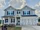 Beautiful two-story home featuring a two-car garage, classic shutters, and a covered front porch at 1654 Tide Mill Rd, Cumming, GA 30040
