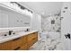 Elegant bathroom with double vanity, modern lighting, and a bathtub/shower combination at 2117 Brannen Se Rd, Atlanta, GA 30316