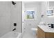 Bathroom featuring a shower over tub, a modern vanity, and stylish fixtures at 2117 Brannen Se Rd, Atlanta, GA 30316