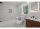 Modern bathroom with tiled walls, a soaking tub, sleek vanity, and contemporary fixtures for a spa-like experience at 2117 Brannen Se Rd, Atlanta, GA 30316