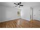 Spacious bedroom featuring hardwood floors, a ceiling fan, and ample natural light from the large windows at 2117 Brannen Se Rd, Atlanta, GA 30316