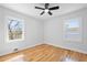 Bright bedroom featuring hardwood floors, a ceiling fan, and windows offering natural light at 2117 Brannen Se Rd, Atlanta, GA 30316