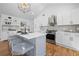 Bright kitchen with stainless appliances, gray island with seating, and modern pendant lighting at 2117 Brannen Se Rd, Atlanta, GA 30316