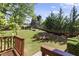 Lush backyard featuring a cozy fire pit, manicured lawn, and mature trees at 3595 Evonvale Overlook, Cumming, GA 30041